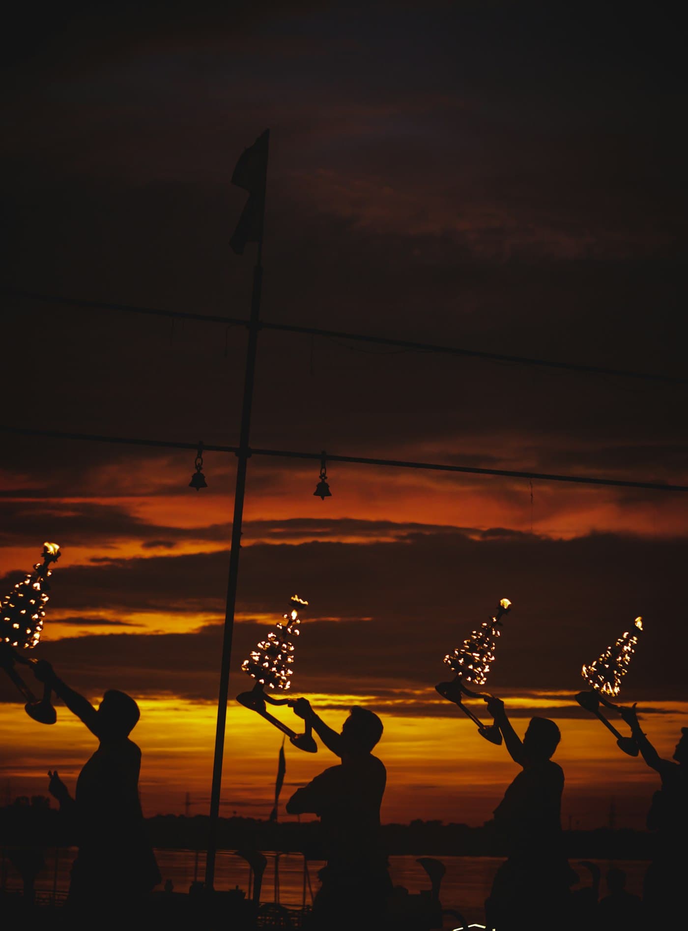 Priests with bells and lamps during a traditional evening ceremony